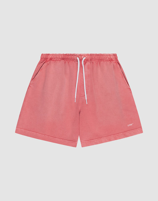 The LIVE FAST DIE YOUNG Basic Sweat Shorts in coral pink feature side pockets, a white drawstring waistband, and a subtle logo on the lower left leg, shown flat on a light background for a minimalist look. | plain