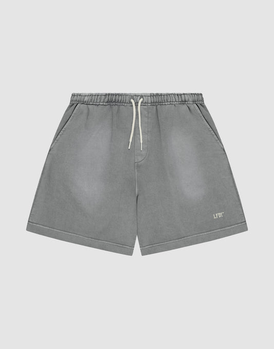 The LIVE FAST DIE YOUNG Basic Sweat Shorts feature a faded gray look, elastic waistband, side pockets, and a small logo print on the left leg, shown against a plain light background. | plain