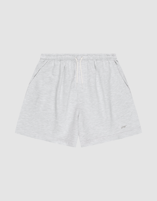 LIVE FAST DIE YOUNG Basic Sweat Shorts in light gray, featuring an elastic waistband, white drawstring, side pockets, and a small LIFTC logo print on the left leg, displayed flat on a plain white background. | plain