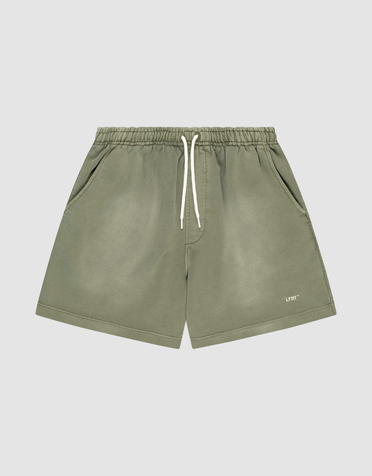 LIVE FAST DIE YOUNG Basic Sweat Shorts in olive green with an elastic waistband, white drawstring, side pockets, oversized fit, subtle faded look, and "LIFTO" logo on the left leg. Shown on a plain light grey background. | plain
