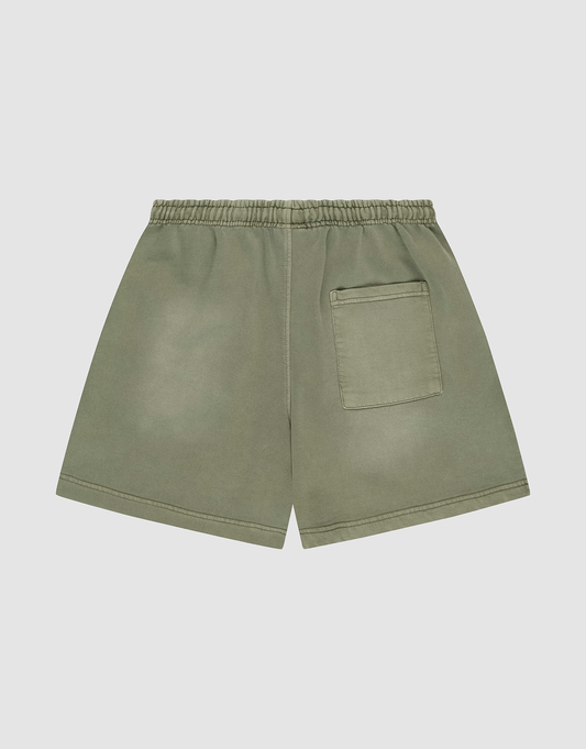 The LIVE FAST DIE YOUNG Basic Sweat Shorts in olive green feature an elastic waistband, a back right patch pocket, and an oversized fit, shown against a plain light gray background.