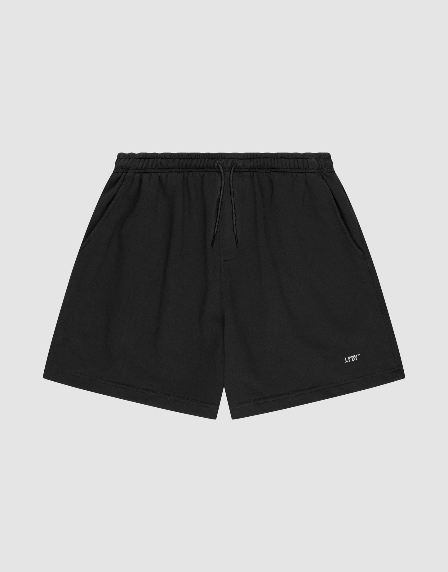 LIVE FAST DIE YOUNG Basic Sweat Shorts in plain black, featuring an elastic waistband, drawstring, side pockets, and a small white logo print on the left leg, shown on a light gray background.