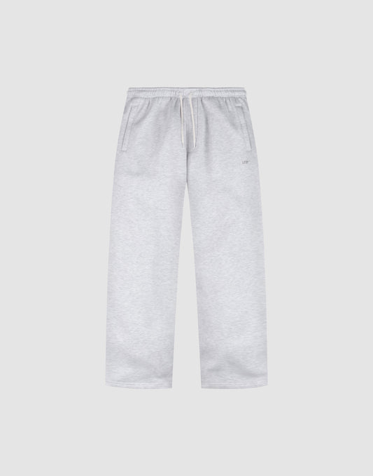 The Basic Wide Jogger by LIVE FAST DIE YOUNG features a light grey color, oversized fit, elastic waistband with drawstring, and side pockets, shown laid flat on a plain white background. | plain