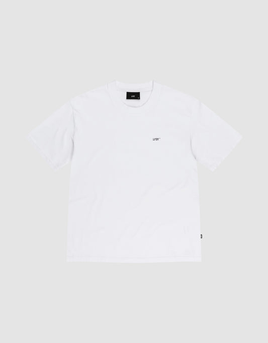 The LIVE FAST DIE YOUNG Basic Chest Tee is a regular fit, short-sleeve white T-shirt made from 100% Baumwolle with a small black UDF logo on the left chest, shown flat on a light gray background.