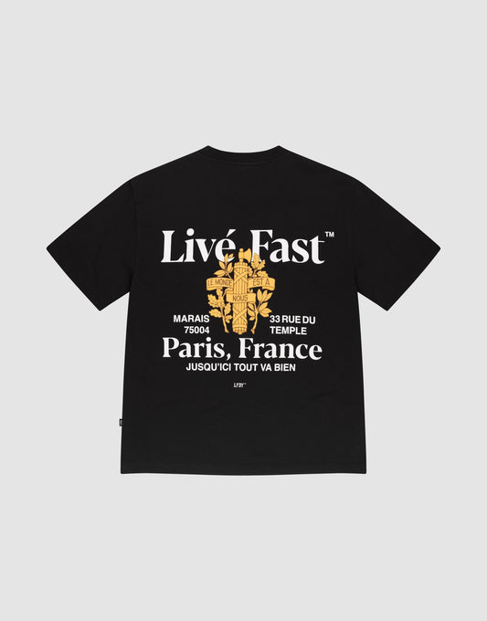 The LFDY Paris Tee by LIVE FAST DIE YOUNG is an oversize black shirt with bold white "Livé Fast" and "Paris, France" text, a yellow rose graphic, front and back prints, and made from 100% Baumwolle for comfort. | plain