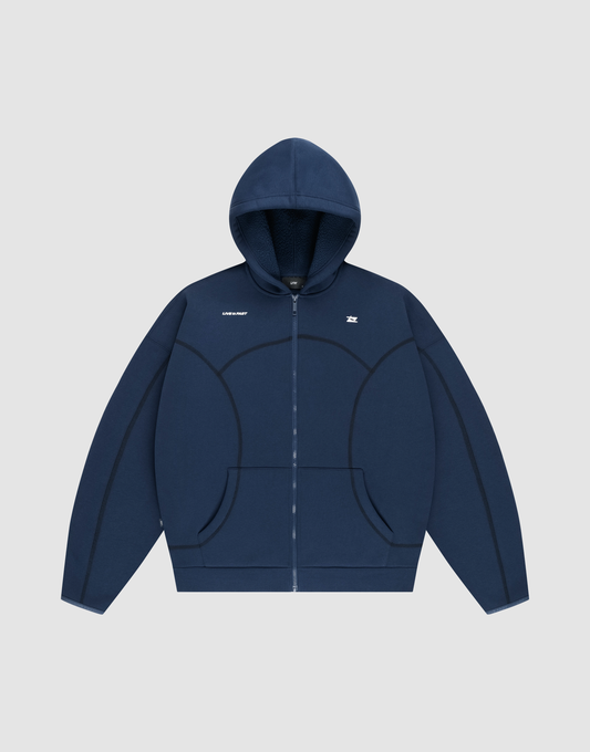 The LFDY Active Fleece Hooded Zip by LIVE FAST DIE YOUNG is a navy oversized zip-up hoodie with a hood, front pockets, black curved seams, and a small white chest logo, made from premium Baumwolle and shown on a light gray background. | plain