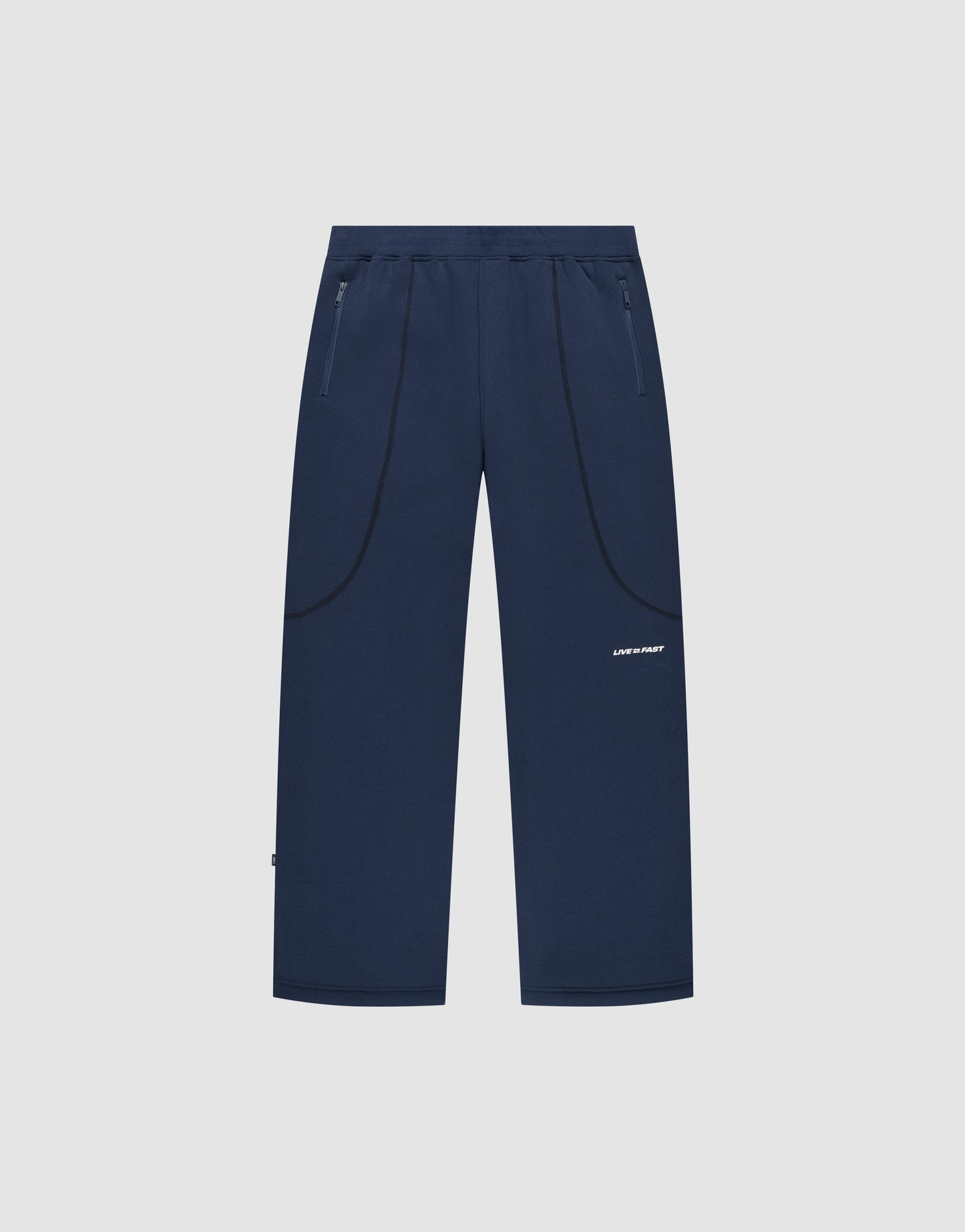 The LFDY Active Fleece Jogger by LIVE FAST DIE YOUNG features navy blue straight legs, zip pockets, subtle curved seams, a small white logo on the left thigh, and a relaxed fit. Displayed on a plain light gray background.