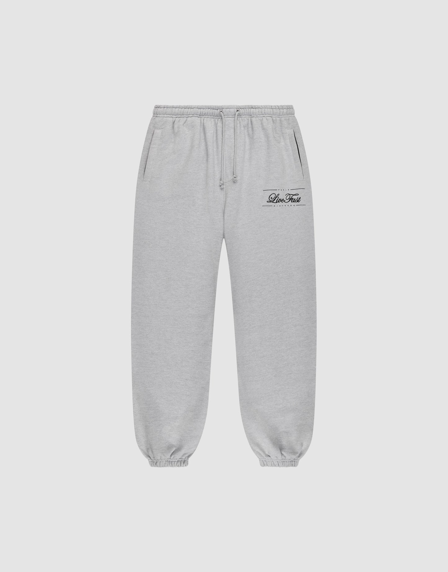 Light gray Wide Cuff Jogger sweatpants by LIVE FAST DIE YOUNG with a wide fit, elastic waistband with drawstring, side pockets, and elastic cuffs. Small black script logo on left thigh. Shown on a plain white background.