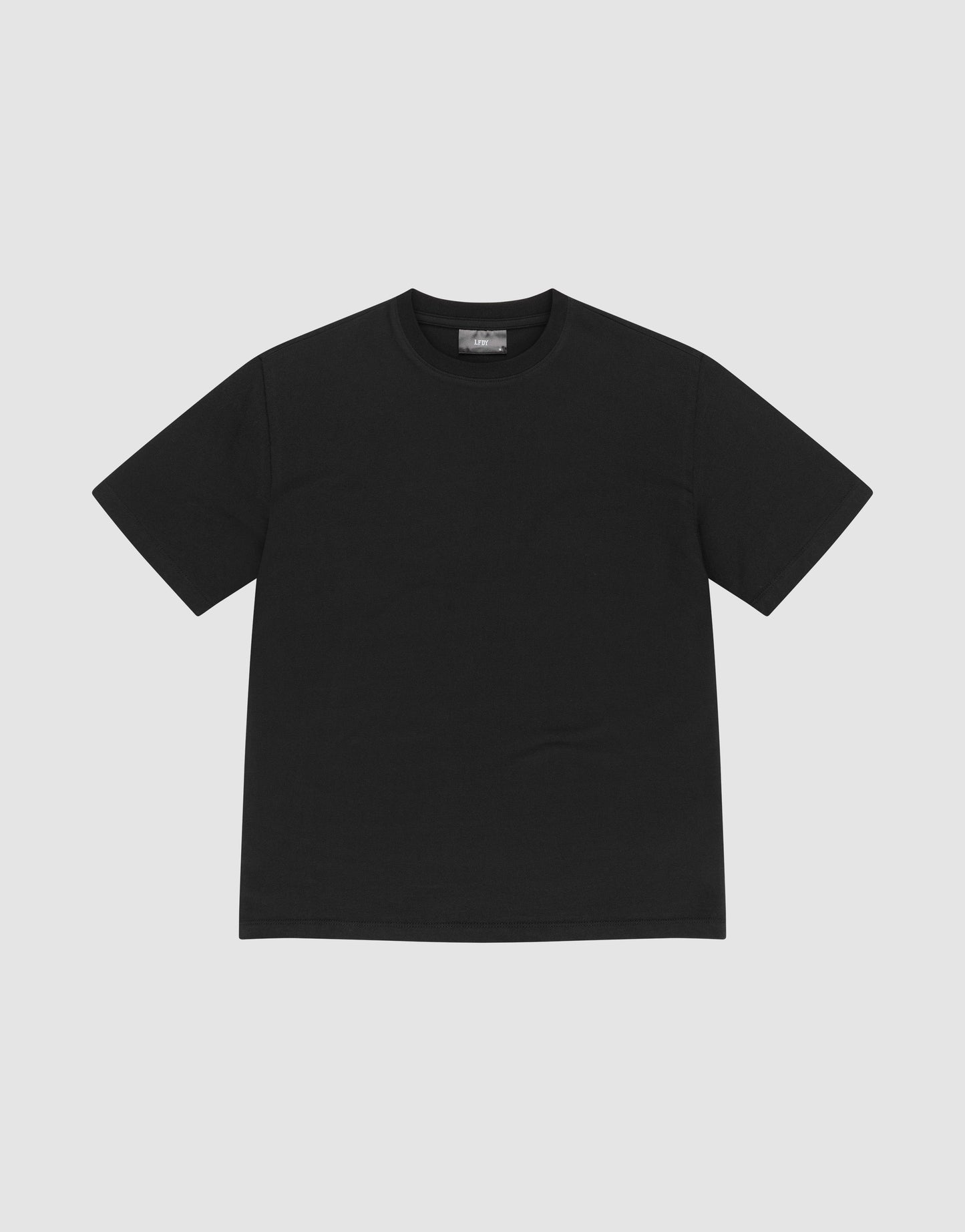 The LFDY Slim Tee by LIVE FAST DIE YOUNG, a plain black slim-fit T-shirt made from soft Baumwolle, is laid flat on a light gray background.