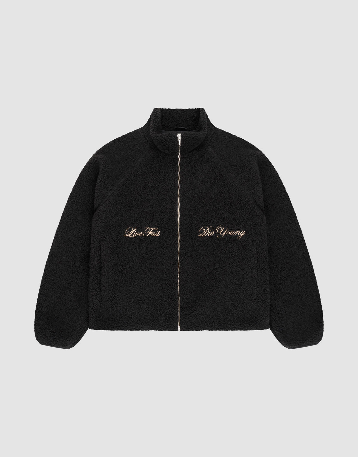 The LFDY Teddy Jacket by LIVE FAST DIE YOUNG is a black fleece jacket with raglan sleeves, side pockets, and gold "Live Fast" and "Die Young" embroidery on the chest, shown on a plain light gray background. | plain