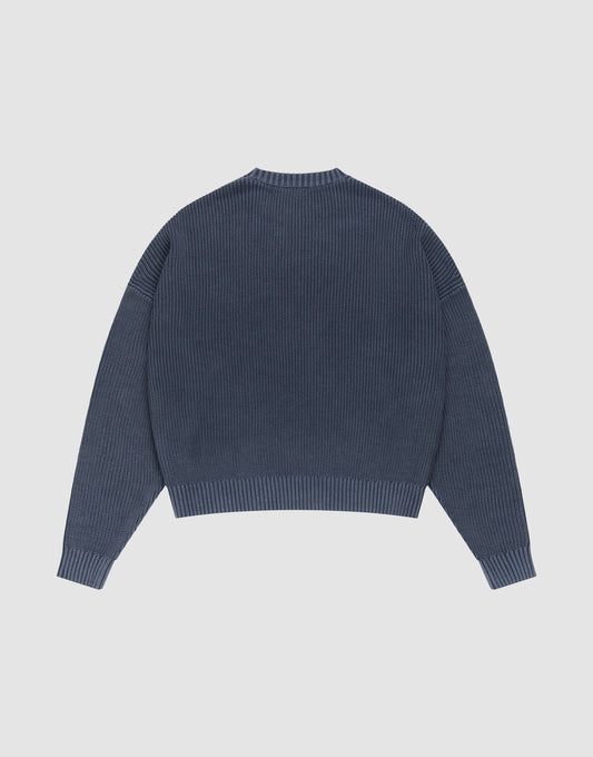 The LFDY Knit Sweater by LIVE FAST DIE YOUNG is shown laid flat from the back. This blue oversized ribbed knit features long sleeves with dropped shoulders, a round neckline, and a straight hem. | plain
