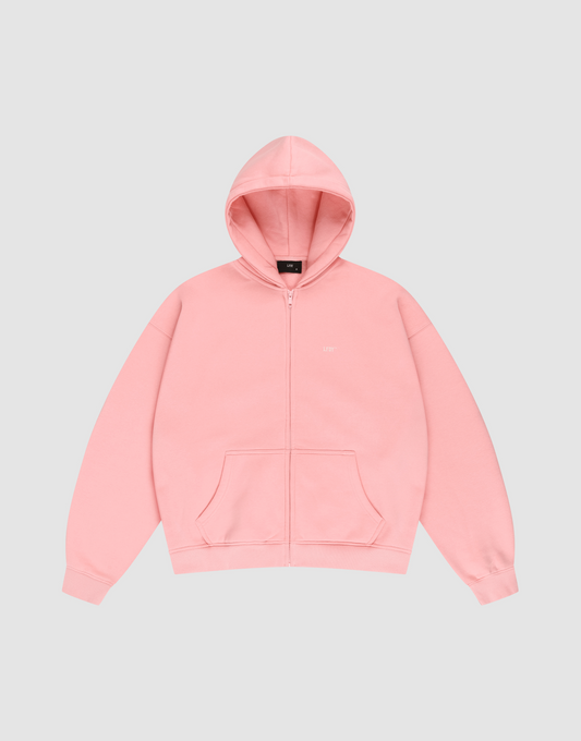 The LIVE FAST DIE YOUNG Basic Hooded Zip is a pink zip-up hoodie with long sleeves, a hood, front pockets, and subtle LFDY branding, shown on a plain light gray background. | plain