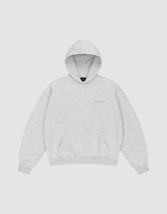 The LIVE FAST DIE YOUNG Basic 360 Hooded is a light gray Oversize Fit sweatshirt with a front pocket and subtle Livefast text on the left chest, made from soft Baumwolle and shown on a plain white background.