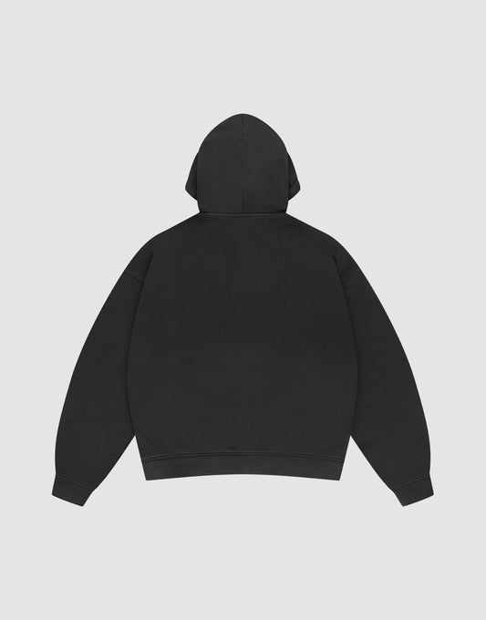 The LIVE FAST DIE YOUNG Basic Hooded Zip is a plain black oversized hoodie shown from the back, featuring a hood, long sleeves, and subtle branding, displayed against a light gray background.