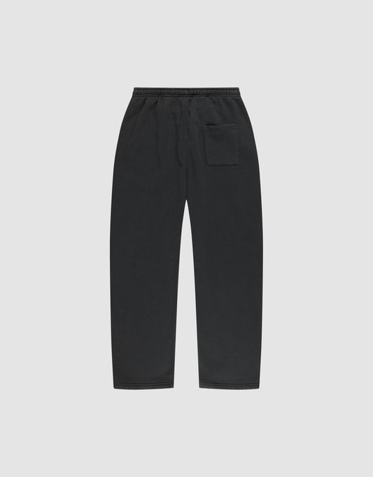 The LIVE FAST DIE YOUNG Basic Wide Jogger features a black wide fit, straight-leg design with an elastic waistband and a single patch pocket on the right, shown flat on a plain light gray background.
