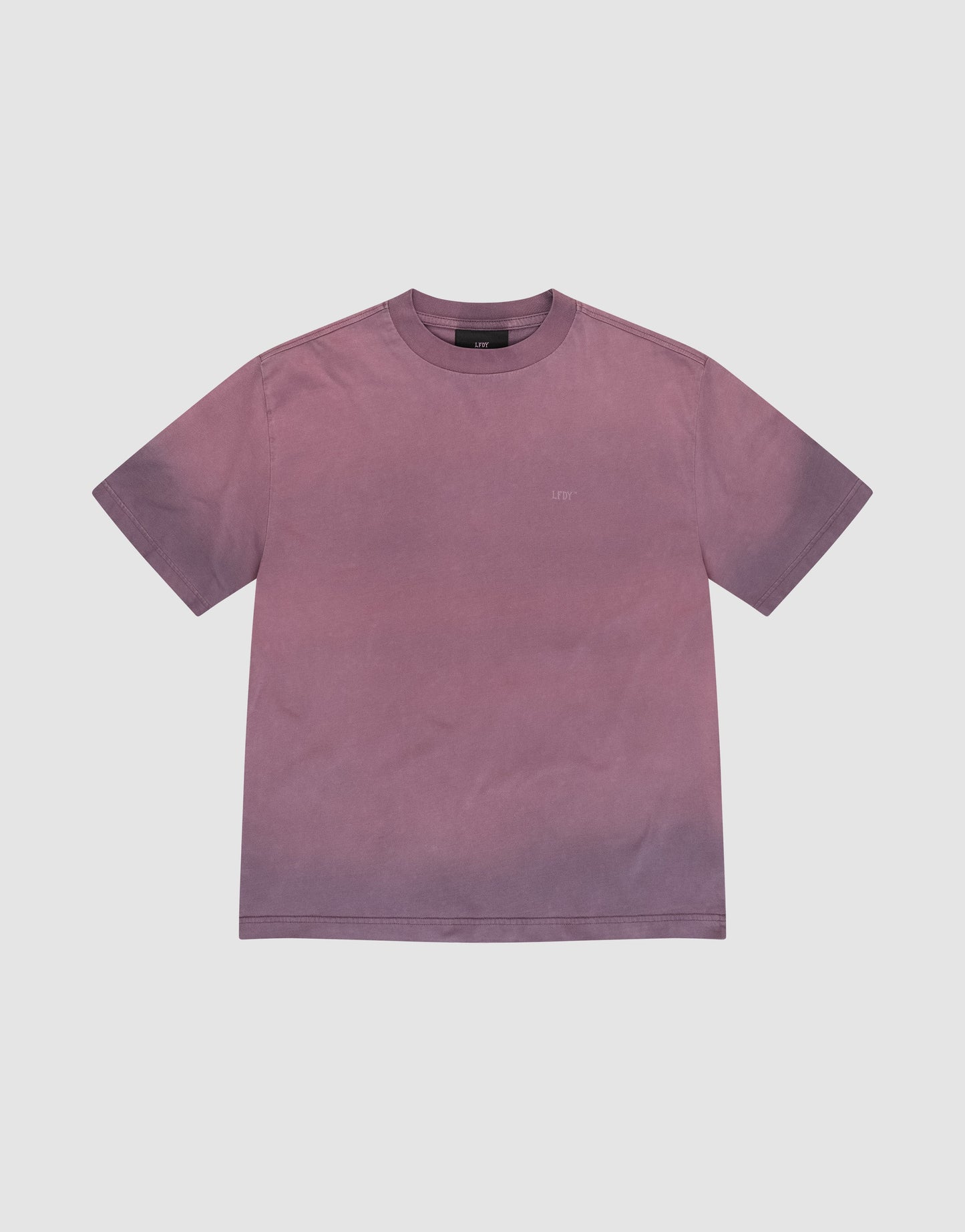 The Live Fast District Tee by LIVE FAST DIE YOUNG is an oversize, short-sleeve crew neck t-shirt in faded mauve-purple with a subtle spray Effekt gradient, shown plain and laid flat on a white background.