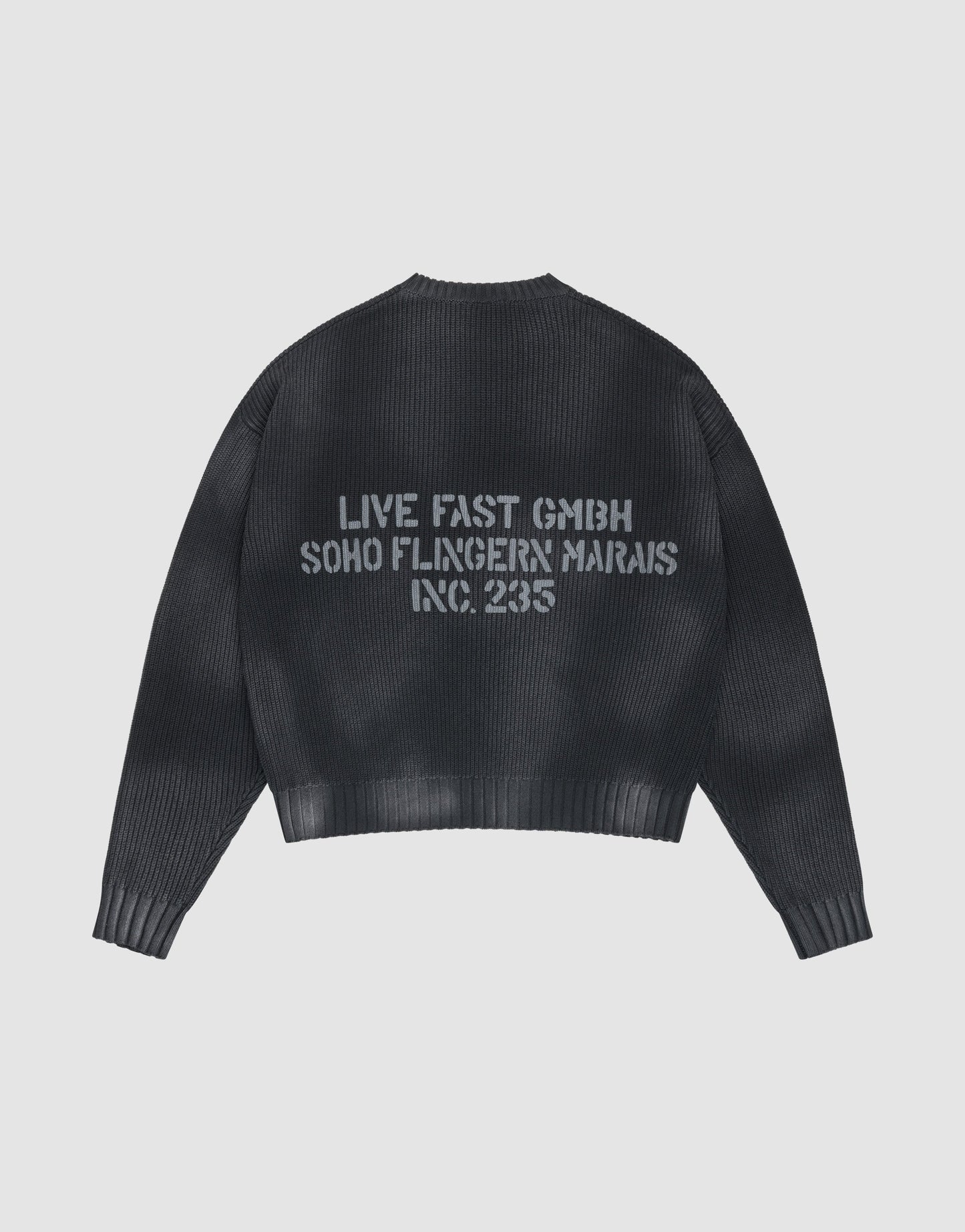 The LFDY Washed Knit Sweater by LIVE FAST DIE YOUNG is black, ribbed, and oversized, with a gray backprint. Made from 100% Baumwolle, it’s shown laid flat on a light gray background.