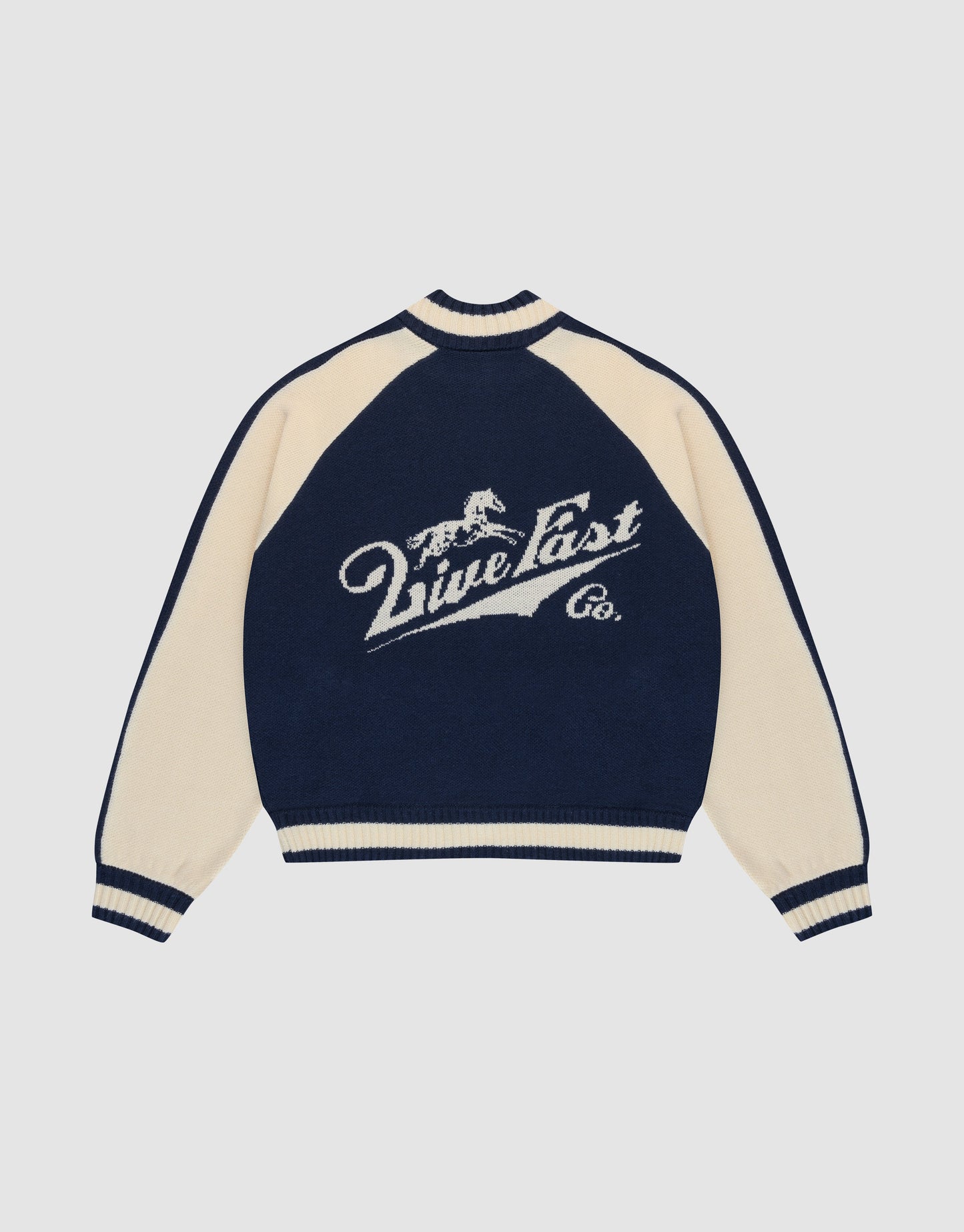 A navy blue and cream Boxy Knit Zip Jacket by LIVE FAST DIE YOUNG, with oversized fit, long raglan sleeves, and a large intarsia-knit running horse graphic above "Live Fast Co." script on the back.