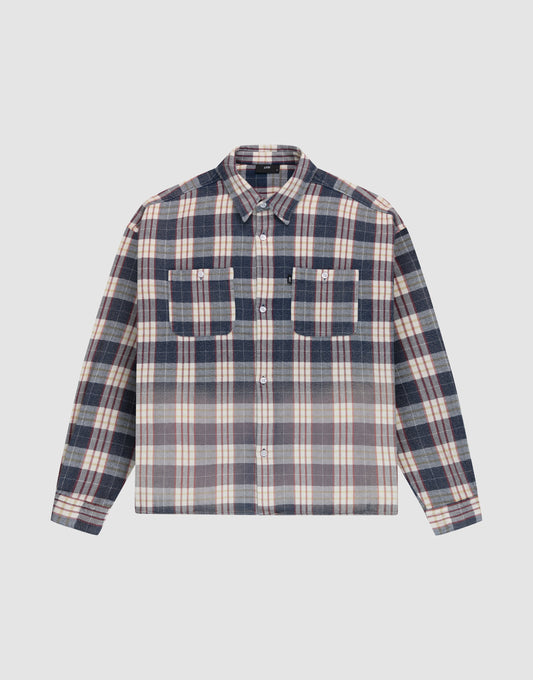 The LIVE FAST DIE YOUNG Vintage Flannel is an oversize, long-sleeve button-up with a Hemdkragen, two chest pockets, and a navy blue, white, and beige striped vintage Waschung pattern. Shirt shown laid flat on a light background. | plain