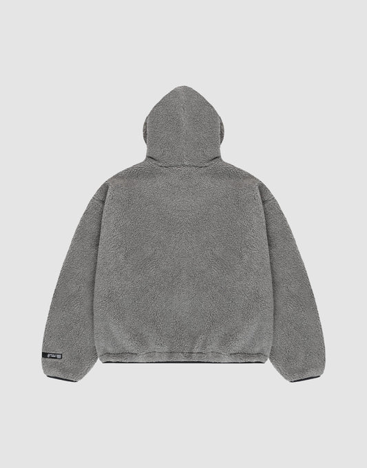 The LIVE FAST DIE YOUNG LFDY Teddy Hooded jacket in gray fleece is shown from the back on a plain light background. It features a soft, plush texture, oversize fit, long sleeves, and a small black tag on the lower left hem.