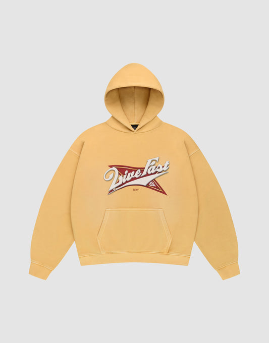 The LFDY Corp. Hooded by LIVE FAST DIE YOUNG is a yellow oversized hoodie with a front pocket and a bold “Drive Fast” graphic over a red and white star on the chest. | plain