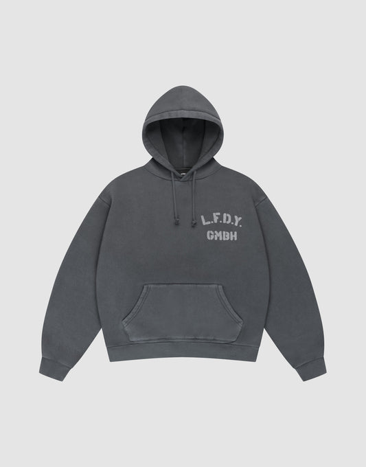 The LIVE FAST DIE YOUNG LFDY GmbH Hooded is a dark gray oversize-fit hoodie with drawstring hood and front pocket, featuring white "L.F.D.Y. GMBH" print on the left chest and subtle vintage wash, shown flat on a light gray background. | plain