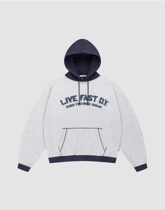 The LFDY District Hooded by LIVE FAST DIE YOUNG features a light gray oversize fit, dark blue contrast hood, cuffs, and hem. Front print: "LIVE FAST D.I.Y." with "BOARD FINGERS PALMS" below. Includes a kangaroo pocket. | plain