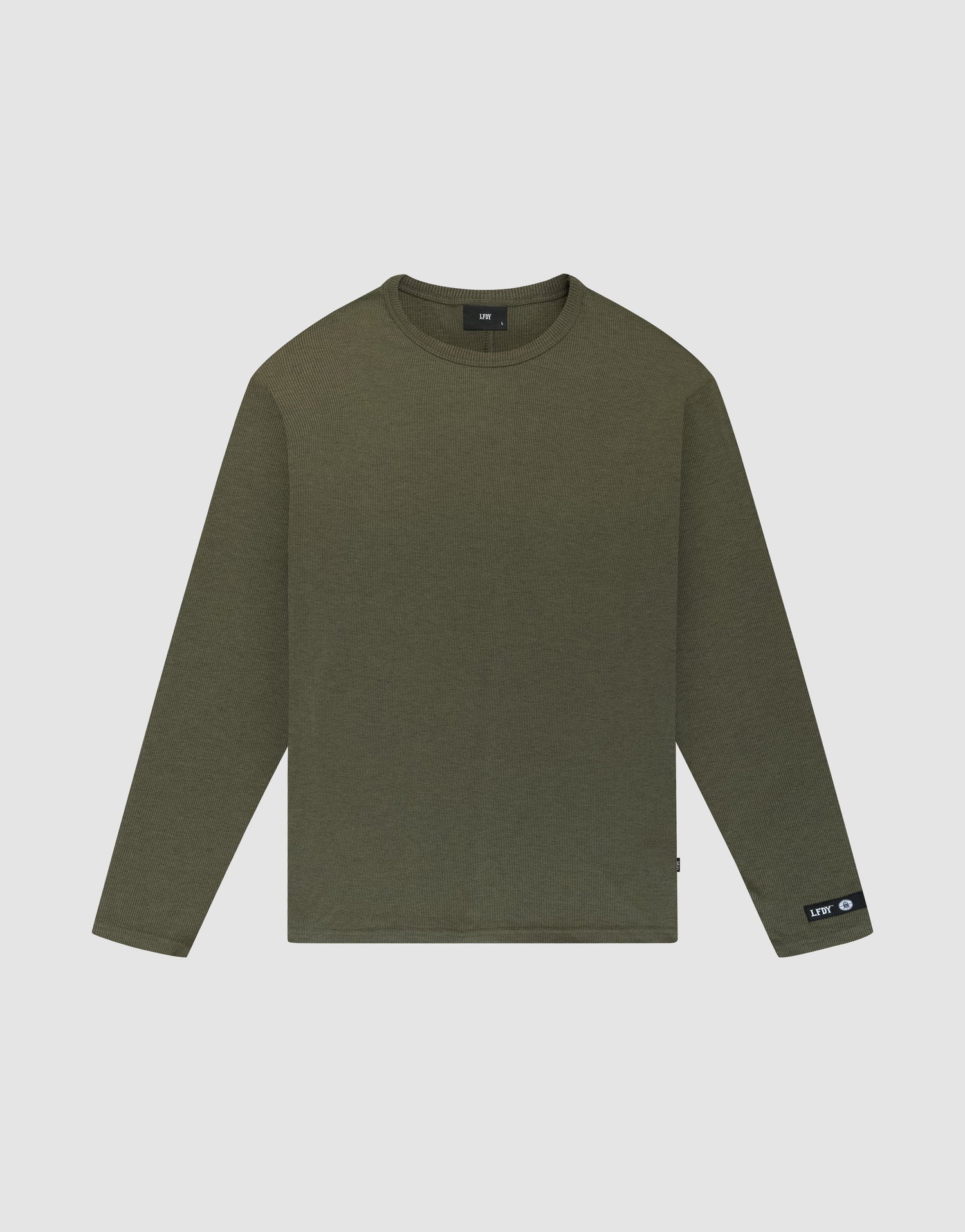 The LFDY Rib Longsleeve by LIVE FAST DIE YOUNG is an oversized, olive green, plain crewneck shirt with long sleeves. It features a small black web-label tag on the left wrist and is displayed flat on a white background. | plain
