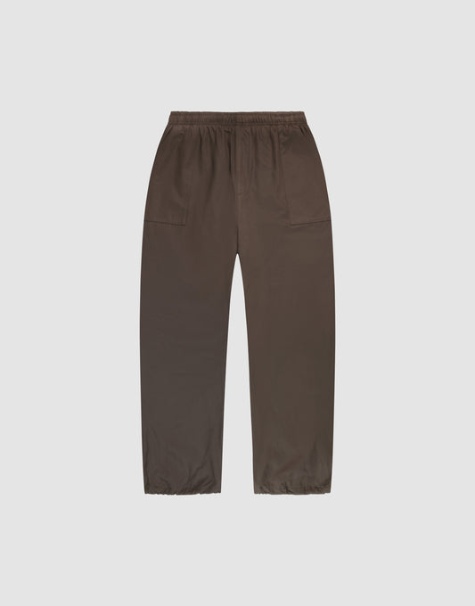 Baggy Nylon Pants by LIVE FAST DIE YOUNG with elastic waistband, wide fit, and large side pockets, shown laid flat on a plain white background. | plain
