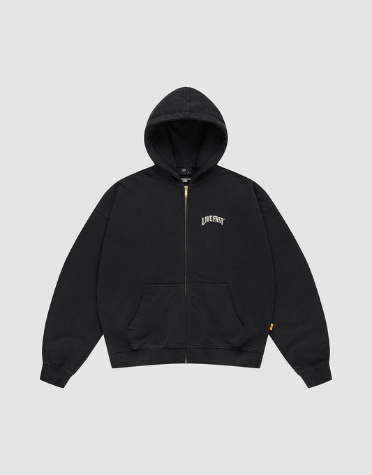 The LFDY x The Bulldog Hooded Zip by LIVE FAST DIE YOUNG is an oversized black zip-up hoodie with front pockets, a hood, and "LIVE FAST" in a white logo print on the left chest. It is shown flat on a plain light gray background.