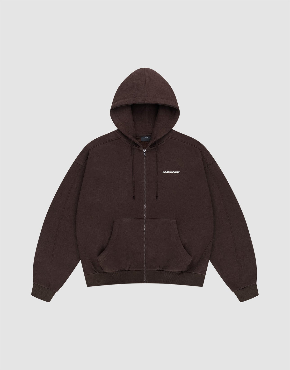The LFDY Pleated Hooded Zip by LIVE FAST DIE YOUNG is a dark brown oversized zip-up hoodie with a drawstring hood, front pockets, and small white LIFE FAST text on the chest. Made from 100% Baumwolle. Shown on a plain light gray background. | plain