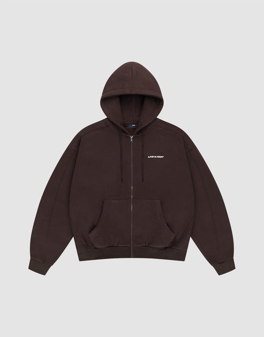 The LFDY Pleated Hooded Zip by LIVE FAST DIE YOUNG is a dark brown oversized zip-up hoodie with a drawstring hood, front pockets, and small white LIFE FAST text on the chest. Made from 100% Baumwolle. Shown on a plain light gray background. | plain
