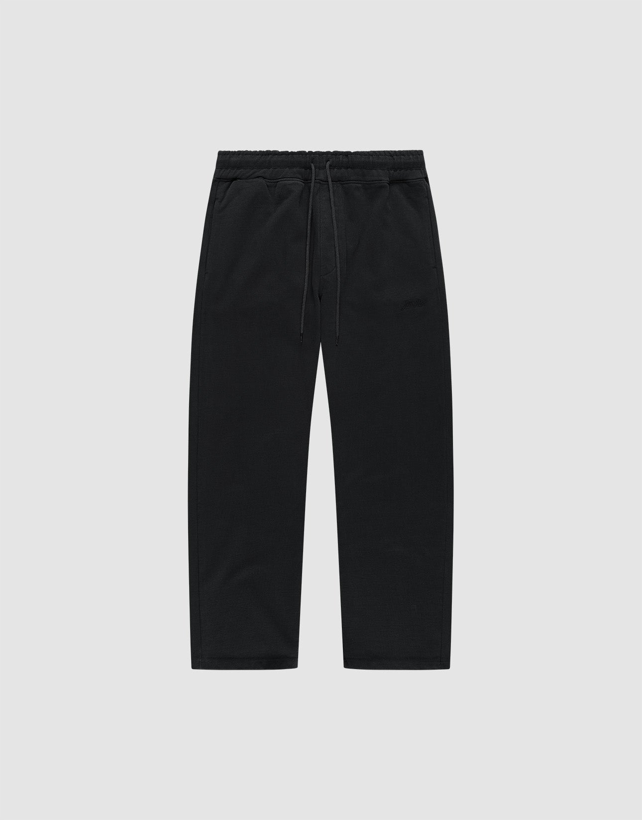 The LIVE FAST DIE YOUNG Basic Wide Jogger is a pair of black, wide-fit cotton pants with an elastic waistband and drawstring, shown flat on a light grey background.