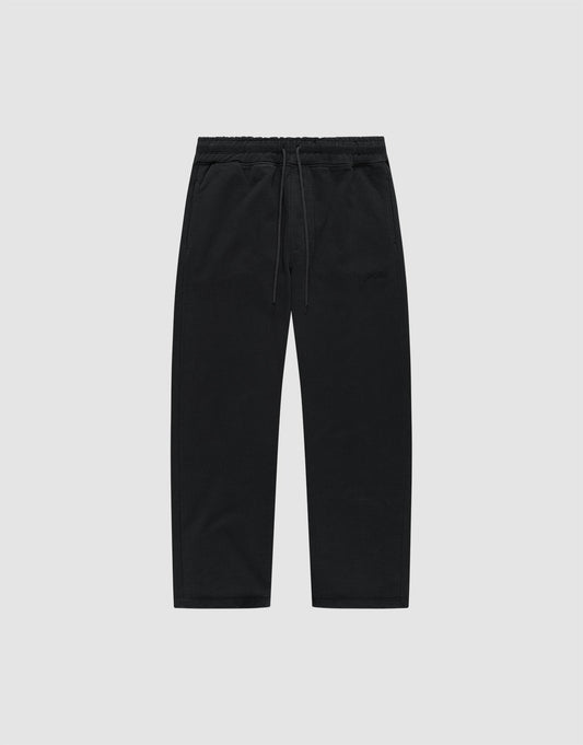 The LIVE FAST DIE YOUNG Basic Wide Jogger is a pair of black, wide-fit cotton pants with an elastic waistband and drawstring, shown flat on a light grey background. | plain