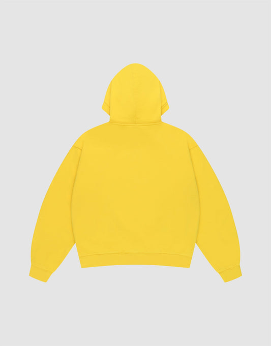 The LIVE FAST DIE YOUNG Live Fast Beware Hooded is a plain yellow oversize fit hoodie, laid flat facing backward on a light gray background. It features long sleeves, double layer 100% Baumwolle fabric, and no visible logos or designs.