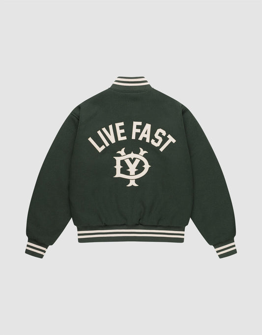 The LIVE FAST DIE YOUNG Live Fast College Jacket is dark green with a DY zipper, white striped cuffs and collar, and features large “LIVE FAST” text above an LV emblem on the back. Shown against a plain light background. | plain