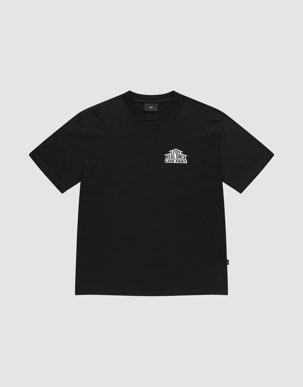 The LFDY Real Ones Tee by LIVE FAST DIE YOUNG is a black, oversize fit, short-sleeve shirt with a small white “The Real Street Real Ones” front graphic. Made from 100% Baumwolle and shown laid flat on a light gray background.