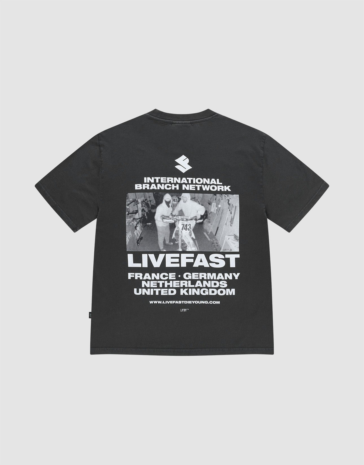 The LFDY Grand Theft Tee by LIVE FAST DIE YOUNG is an oversized black T-shirt made from 100% cotton, featuring bold front and back prints of runners, “INTERNATIONAL BRANCH NETWORK,” “LIVEFAST,” and country names. | plain
