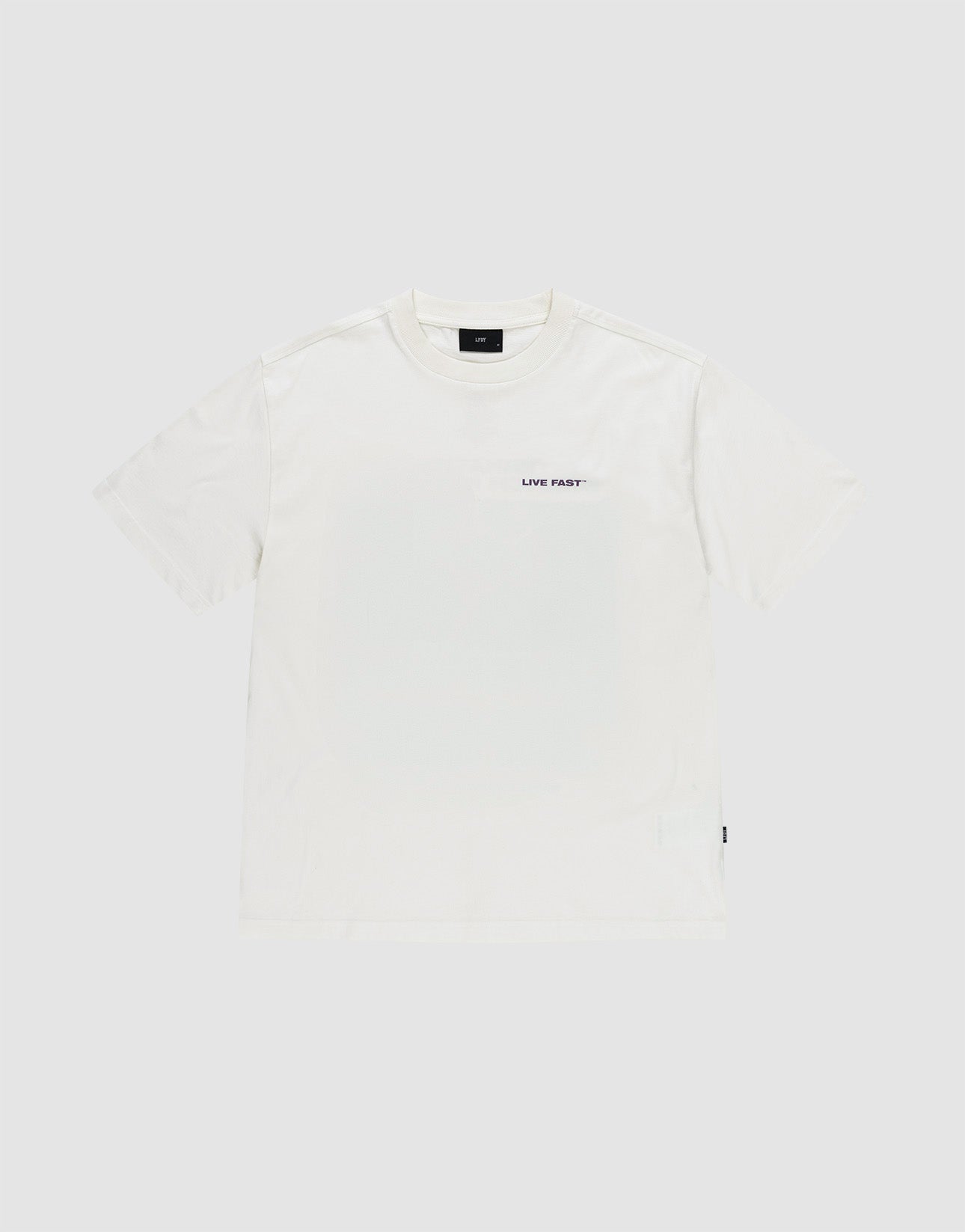 The LFDY Grand Theft Tee by LIVE FAST DIE YOUNG is a plain white oversized 100% Baumwolle short-sleeve t-shirt with a small black "LIVE FAST" text on the left chest, shown against a light grey background.