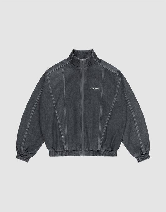 The LFDY Denim Trackjacket by LIVE FAST DIE YOUNG is dark gray, 100% Baumwolle, with a front zipper, stand collar, elastic cuffs and hem, white seams, and "LIFE PAINT" in white text on the left chest. Shown laid flat on a light background. | plain