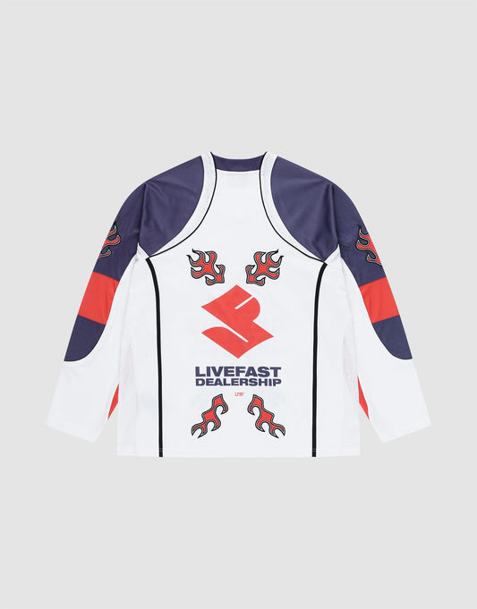 The LFDY Call Us Jersey by LIVE FAST DIE YOUNG is an oversized white long-sleeve shirt with navy and red accents, flame graphics on the shoulders, and a bold stylized LIVEFAST DEALERSHIP logo on the back.