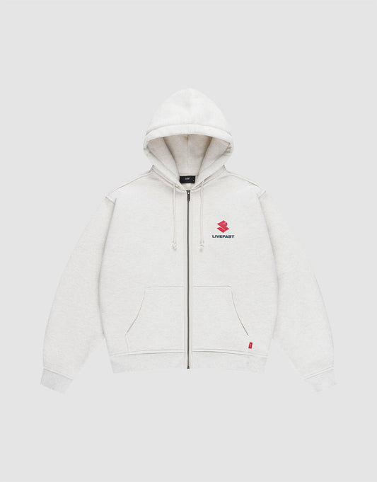 The LFDY Heavyweight Lounge Zip Hooded by LIVE FAST DIE YOUNG is a light gray, 100% Baumwolle zip-hoodie with front pockets, hood and drawstrings, minimalist design, and a small red Suzuki logo plus "LIVE FAST" on the left chest. Regular fit. | plain