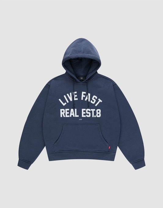 The LFDY Heavyweight Lounge Hooded by LIVE FAST DIE YOUNG is a navy blue regular-fit hoodie made from 100% Baumwolle, featuring a front pocket and "LIVE FAST REAL EST.8" in bold white letters across the chest. | plain