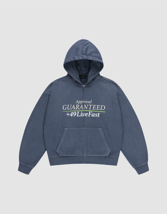The LFDY Guaranteed Hooded Zip by LIVE FAST DIE YOUNG is a blue oversized zip-up hoodie with front pockets, featuring a bold front print reading "Approval GUARANTEED +49LiveFast," and made from 100% Baumwolle for comfort. | plain
