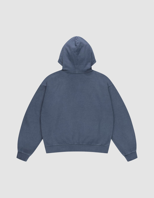 The LFDY Guaranteed Hooded Zip by LIVE FAST DIE YOUNG is shown from the back in plain blue, featuring an oversize fit, long sleeves, ribbed cuffs and waistband. Crafted from 100% Baumwolle and set against a light gray background.