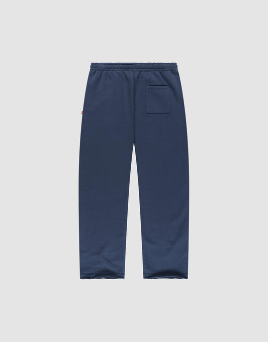 The LFDY Heavyweight Loungepants by LIVE FAST DIE YOUNG are navy blue wide fit joggers made from 100% cotton, with an elastic waistband and a single back pocket, shown flat on a plain light gray background.