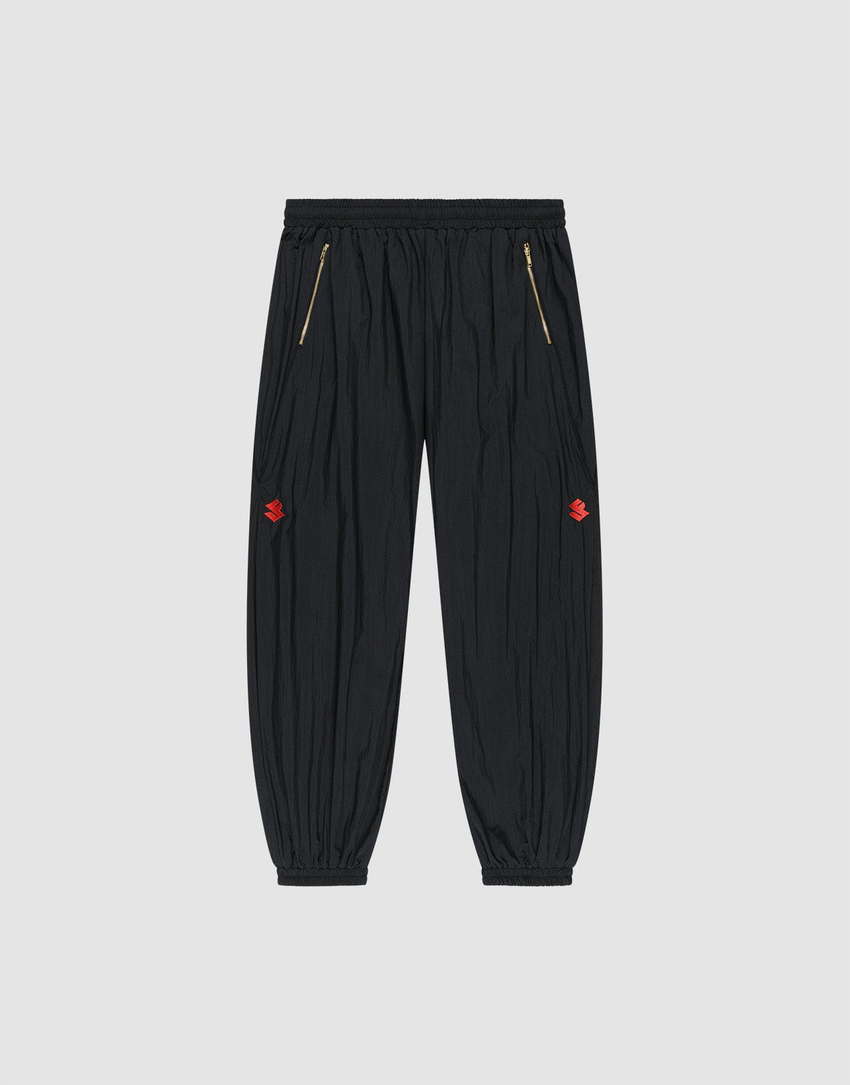 The LFDY Dealership Trackpants by LIVE FAST DIE YOUNG feature an elastic waistband, gold zippered side pockets, ankle cuffs, and small red embroidered thigh logos. Made from comfortable polyamide. Shown against a light gray background. | plain