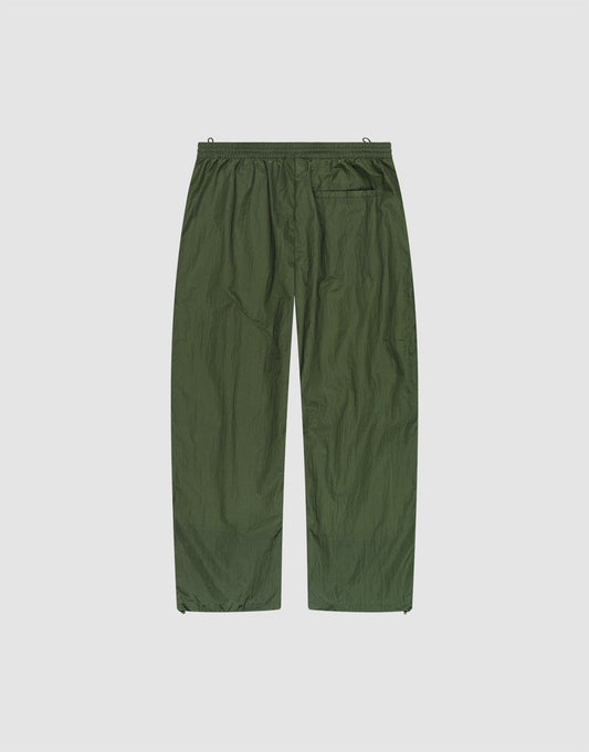 The LFDY Nylon Trackpants by LIVE FAST DIE YOUNG feature olive green, lightweight polyamide nylon, an elastic waistband, wide straight legs, and a single back pocket, shown flat on a plain white background.