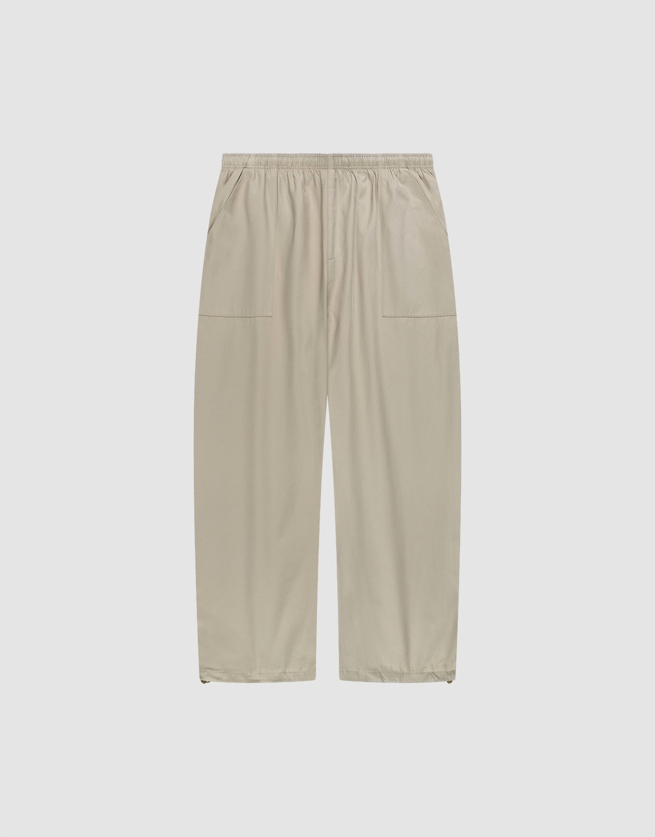 Baggy Nylon Pants by LIVE FAST DIE YOUNG in beige with a wide fit, elastic waistband, and large patch pockets, shown flat on a plain white background. | plain