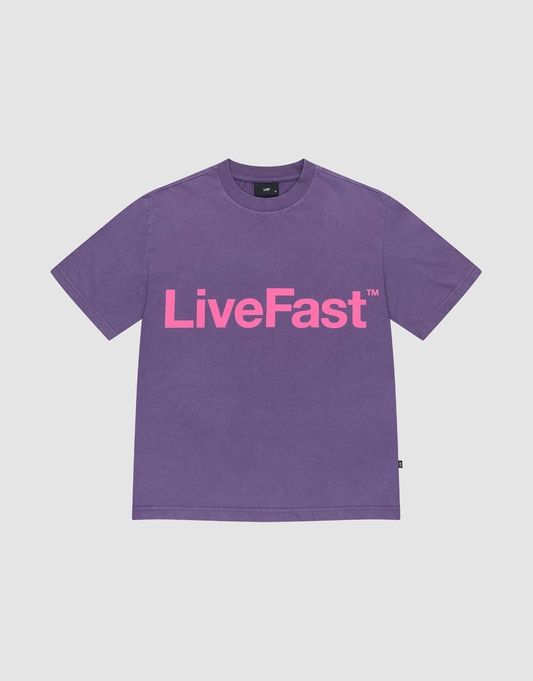 The Basic OS Livefast Tee by LIVE FAST DIE YOUNG is a purple t-shirt with a bold Frontprint: LiveFast™ in large pink letters. Made from 100% Baumwolle, it features short sleeves and a round neckline for all-day comfort. | plain